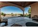 Spacious covered patio with stone archway, seating area, and scenic outdoor views at 3718 N Briere Ct, Buckeye, AZ 85396