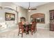 Dining room showcases a large table, recessed lighting, and elegant window shutters at 3718 N Briere Ct, Buckeye, AZ 85396