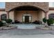 Close-up of a home's grand entrance, complete with stone archway and ornate wood door at 3718 N Briere Ct, Buckeye, AZ 85396