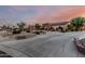 Captivating property with a spacious driveway, manicured landscaping, and a picturesque setting at sunset at 3718 N Briere Ct, Buckeye, AZ 85396