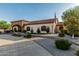 Charming exterior featuring an arched entryway, lush landscaping, and a well-maintained lawn at 3718 N Briere Ct, Buckeye, AZ 85396