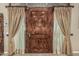 Beautiful wood front door with sidelights and decorative curtains, inviting entry at 3718 N Briere Ct, Buckeye, AZ 85396