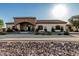 Expansive home exterior with a statement stone entrance and desert-style landscaping at 3718 N Briere Ct, Buckeye, AZ 85396