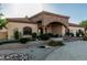 Stunning home featuring a grand stone entrance and well-manicured landscaping at 3718 N Briere Ct, Buckeye, AZ 85396