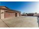 Spacious three-car garage with a large driveway, providing ample parking for multiple vehicles at 3718 N Briere Ct, Buckeye, AZ 85396