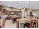 Gourmet kitchen features custom cabinets, granite countertops, a large island, and stainless appliances at 3718 N Briere Ct, Buckeye, AZ 85396