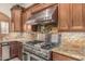 Gourmet kitchen featuring stainless steel appliances, granite countertops, and custom wood cabinetry at 3718 N Briere Ct, Buckeye, AZ 85396