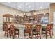 Gourmet kitchen featuring custom cabinets, granite countertops, and stainless steel appliances at 3718 N Briere Ct, Buckeye, AZ 85396