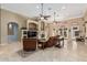 Open living room with tile flooring, fireplace, and plenty of natural light at 3718 N Briere Ct, Buckeye, AZ 85396