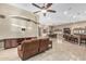 Open-concept living space showcases travertine floors, custom furniture, and recessed lighting at 3718 N Briere Ct, Buckeye, AZ 85396