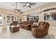 Spacious living room with tiled floors, comfortable seating, and open-concept design at 3718 N Briere Ct, Buckeye, AZ 85396
