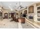 Comfortable living room with a fireplace, tiled floors, and sophisticated decor at 3718 N Briere Ct, Buckeye, AZ 85396