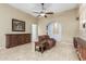 Comfortable living room features travertine flooring, recessed lighting, and traditional furnishings at 3718 N Briere Ct, Buckeye, AZ 85396