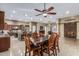 Open-concept living space including kitchen, dining room, and living room with travertine floors at 3718 N Briere Ct, Buckeye, AZ 85396