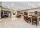 Expansive living space includes living, dining, and kitchen areas with travertine flooring at 3718 N Briere Ct, Buckeye, AZ 85396