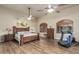 Spacious main bedroom with wood floors, ceiling fans and abundant natural light at 3718 N Briere Ct, Buckeye, AZ 85396