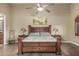 Spacious main bedroom features wood-look floors, ceiling fan, and access to the main bath at 3718 N Briere Ct, Buckeye, AZ 85396