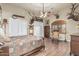 Cozy main bedroom featuring hardwood floors, neutral walls, and unique mounted deer head decor at 3718 N Briere Ct, Buckeye, AZ 85396