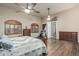 Large main bedroom features wood floors, a ceiling fan, and wood shuttered windows at 3718 N Briere Ct, Buckeye, AZ 85396