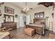 An ample main bedroom featuring wood floors, a large bed, and rustic decor at 3718 N Briere Ct, Buckeye, AZ 85396