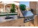 A fully equipped outdoor kitchen with sink and grill, perfect for al fresco dining and entertaining at 3718 N Briere Ct, Buckeye, AZ 85396