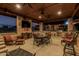 Covered patio with outdoor kitchen, seating, dining area and television perfect for entertaining at 3718 N Briere Ct, Buckeye, AZ 85396