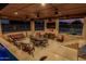A covered outdoor living area includes comfortable seating, a dining table, and an outdoor TV for entertaining at 3718 N Briere Ct, Buckeye, AZ 85396