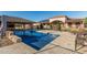 Inviting pool area with an outdoor kitchen and ample seating for entertaining and relaxation at 3718 N Briere Ct, Buckeye, AZ 85396