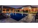 Inviting backyard pool with covered patio and lush landscaping, perfect for relaxation and outdoor entertaining at 3718 N Briere Ct, Buckeye, AZ 85396