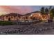 Backyard pool and outdoor kitchen under the sunset sky at 3718 N Briere Ct, Buckeye, AZ 85396