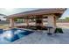 Enjoy poolside entertainment with a fully equipped outdoor kitchen and spacious seating area at 3718 N Briere Ct, Buckeye, AZ 85396