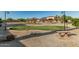 Backyard putting green perfect for honing your skills in a beautifully landscaped setting at 3718 N Briere Ct, Buckeye, AZ 85396