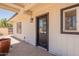 View of back porch with decorative plant and black trimmed entry door at 4001 E Apollo Rd, Phoenix, AZ 85042