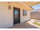 View of back porch with decorative plant and black trimmed entry door at 4001 E Apollo Rd, Phoenix, AZ 85042
