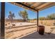Covered patio looking out to large backyard with basketball court and block wall at 4001 E Apollo Rd, Phoenix, AZ 85042