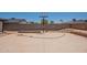 Desert landscaped backyard with a basketball court, retaining walls, and space for outdoor activities at 4001 E Apollo Rd, Phoenix, AZ 85042