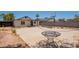 Desert backyard with a basketball court, mature trees, and a metal table for relaxing and entertaining at 4001 E Apollo Rd, Phoenix, AZ 85042