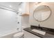 Bright bathroom featuring tiled shower and a vanity with dark countertop at 4001 E Apollo Rd, Phoenix, AZ 85042