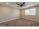 Neutral bedroom featuring plush carpet, a ceiling fan, and a window bringing in natural light at 4001 E Apollo Rd, Phoenix, AZ 85042