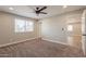 Cozy bedroom features a ceiling fan, carpet flooring and views into adjacent rooms at 4001 E Apollo Rd, Phoenix, AZ 85042