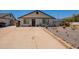Charming single-story home with a desert landscape front yard and a spacious driveway at 4001 E Apollo Rd, Phoenix, AZ 85042