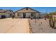Charming single-story home with a low-maintenance desert landscape and a spacious driveway at 4001 E Apollo Rd, Phoenix, AZ 85042