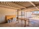 Organized garage space with shelving and a table, providing ample storage and workspace at 4001 E Apollo Rd, Phoenix, AZ 85042