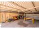 Spacious garage interior with workbench, shelving, and visible brick wall at 4001 E Apollo Rd, Phoenix, AZ 85042