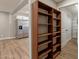 Hallway with shelving leading into kitchen with stainless steel refrigerator at 4001 E Apollo Rd, Phoenix, AZ 85042