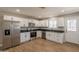 Modern kitchen with white cabinets, stainless steel appliances, black countertops, and tile flooring at 4001 E Apollo Rd, Phoenix, AZ 85042