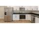 Modern kitchen featuring stainless steel appliances, white cabinets, and stylish countertops at 4001 E Apollo Rd, Phoenix, AZ 85042