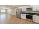 Open floor plan showcasing a kitchen with stainless steel appliances and adjacent living area at 4001 E Apollo Rd, Phoenix, AZ 85042
