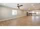 Bright living room with recessed lights, tile flooring, a ceiling fan, and an open view of the kitchen at 4001 E Apollo Rd, Phoenix, AZ 85042