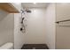 Tiled shower with white subway tiles, a black shower head, and a black tiled floor at 4001 E Apollo Rd, Phoenix, AZ 85042